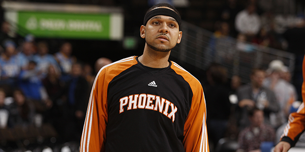 Phoenix Suns forward Jared Dudley warms up before facing the Denver Nuggets in the first quarter of...