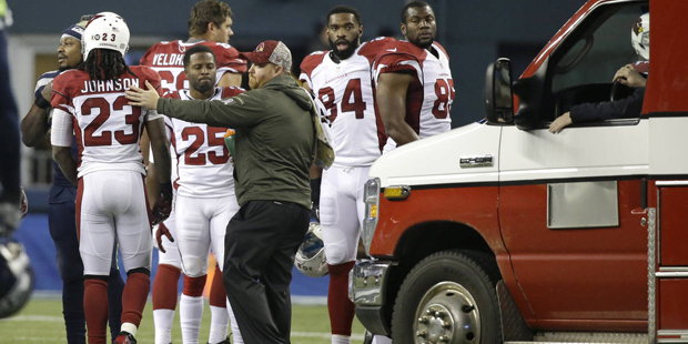 An ambulance is brought in to take injured Arizona Cardinals guard Mike Iupati off the field after ...