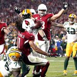 Arizona Cardinals wide receiver Larry Fitzgerald (11) scores the game-winning touchdown against the Green Bay Packers during overtime of an NFL divisional playoff football game, Saturday, Jan. 16, 2016, in Glendale, Ariz. The Cardinals won 26-20 in overtime. (Rob Schumacher/The Arizona Republic via AP)  MARICOPA COUNTY OUT; MAGS OUT; NO SALES; MANDATORY CREDIT