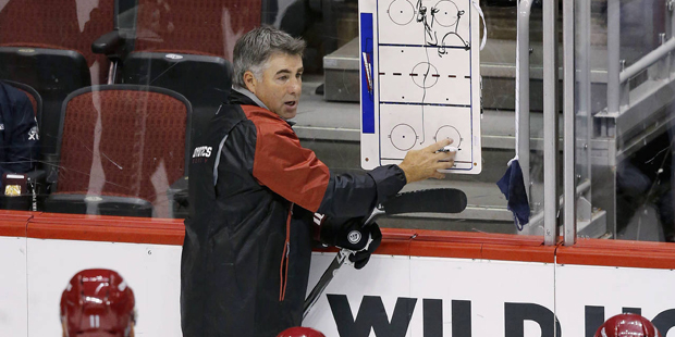 Arizona Coyotes coach Dave Tippett talks to his players during the first full day of NHL hockey tra...