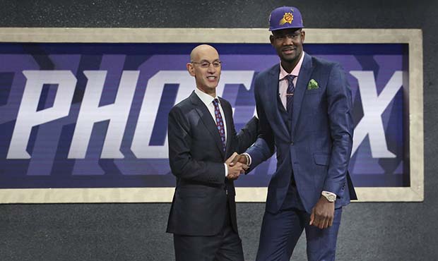 Arizona's Deandre Ayton, right, poses with NBA Commissioner Adam Silver after he was picked first o...