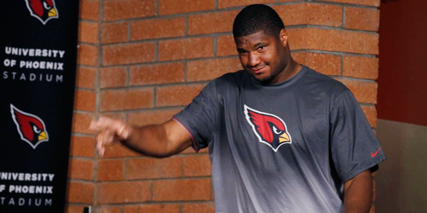 Arizona Cardinals' Calais Campbell waves to reporters as he arrives for a news conference at the NF...