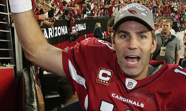 Arizona Cardinals' Kurt Warner celebrates with fans as he leaves the field after the Cardinals vict...