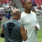Receiver Michael Floyd talks with strength and conditioning coach Buddy Morris during Arizona Cardinals training camp Aug. 10. (Photo by Adam Green/Arizona Sports)