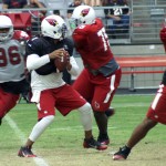 Phillip Sims looks for a receiver during Cardinals training camp Aug. 19. (Photo: Adam Green/Arizona Sports)