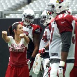 Dr. Jen Welter, an intern coaching inside linebackers, demonstrates for a player during training camp Aug. 3. (Photo by Adam Green/Arizona Sports)