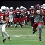 Receiver Larry Fitzgerald corrals a pass while Tyrann Mathieu defends during training camp Aug. 24. (Photo: Adam Green/Arizona Sports)