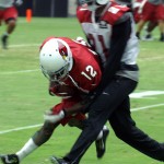 Receiver John Brown is tackled by cornerback Patrick Peterson after making a catch during Arizona Cardinals training camp Aug.12. (Photo by Adam Green/Arizona Sports)