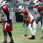 LaMarr Woodley, Kevin Minter and Alani Fua wait for the snap during Cardinals training camp Aug. 19. (Photo: Adam Green/Arizona Sports)