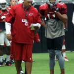 Offensive coordinator Harold Goodwin talks with receiver Larry Fitzgerald during Arizona Cardinals training camp Aug.12. (Photo by Adam Green/Arizona Sports)