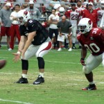 QB Drew Stanton reaches down for a low snap during Arizona Cardinals training camp Aug. 7. (Photo by Adam Green/Arizona Sports)