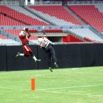 Receiver John Brown makes a leaping catch over Jerraud Powers  during training camp Aug. 13. (Photo by: Adam Green/Arizona Sports)