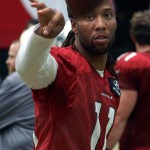Receiver Larry Fitzgerald tosses a football during Cardinals training camp Aug. 19. (Photo: Adam Green/Arizona Sports)