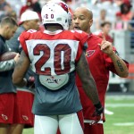 Inside linebackers coach Larry Foote talks with safety Deone Bucannon during training camp Aug. 17. (Photo: Adam Green/Arizona Sports)