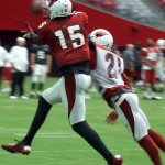 CB Patrick Peterson reaches in and breaks up a pass intended for WR Michael Floyd during training camp Aug. 3. (Photo by Adam Green/Arizona Sports)