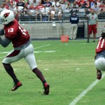 Receiver Jaron Brown makes a catch while Larry Fitzgerald sets up to block during Arizona Cardinals training camp Aug. 5. (Photo by Adam Green/Arizona Sports)
