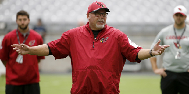 Arizona Cardinals head coach Bruce Arians instructs his players during an NFL football training cam...
