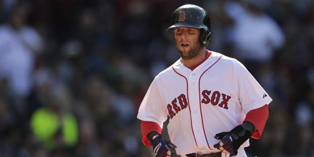 Boston Red Sox Dustin Pedroia heads back to the dugout after scoring during a baseball game at Fenw...