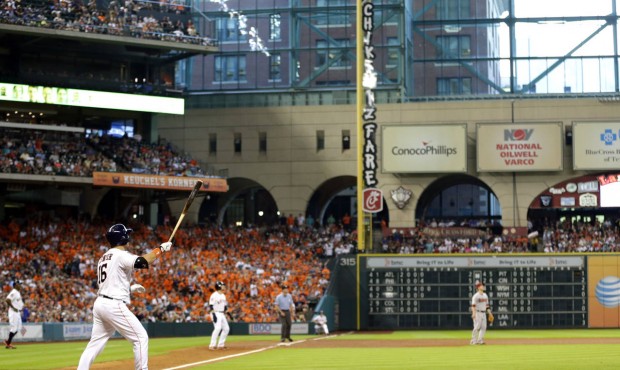 Houston Astros' Hank Conger (16) watches his grand slam against the Arizona Diamondbacks during the...