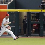 Philadelphia Phillies' Jeff Francoeur tries to catch up with a line drive hit by Arizona Diamondbacks' Paul Goldschmidt during the fifth inning of a baseball game Wednesday, Aug. 12, 2015, in Phoenix. Goldschmidt ended up with a triple on the play, scoring Diamondbacks' Ender Inciarte. (AP Photo/Ross D. Franklin)