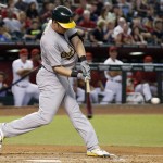Oakland Athletics' Mark Canha connects for a run-scoring double against the Arizona Diamondbacks during the third inning of a baseball game Friday, Aug. 28, 2015, in Phoenix. (AP Photo/Ross D. Franklin)