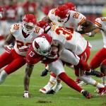 Kansas City Chiefs cornerback Marcus Cooper (31) hits Arizona Cardinals wide receiver Jaron Brown (13) as Steven Nelson (20) and Eric Berry (29) defend during the first half of an NFL preseason football game, Saturday, Aug. 15, 2015, in Glendale, Ariz. (AP Photo/Rick Scuteri)