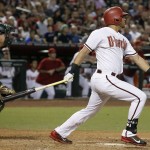Arizona Diamondbacks' David Peralta watches his RBI double in front of Oakland Athletics catcher Stephen Vogt during the sixth inning of a baseball game Friday, Aug. 28, 2015, in Phoenix. (AP Photo/Ross D. Franklin)