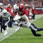 Arizona Cardinals running back David Johnson (31) leaps over San Diego Chargers defensive back Jahleel Addae (37) as Kavell Conner (53) watches during the first half of an NFL preseason football game, Saturday, Aug. 22, 2015, in Glendale, Ariz. (AP Photo/Rick Scuteri)