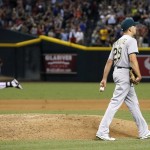 Oakland Athletics' Pat Venditte (29) walks around the mound after giving up a two-run home run to Arizona Diamondbacks' Paul Goldschmidt, left, during the seventh inning of a baseball game Friday, Aug. 28, 2015, in Phoenix. (AP Photo/Ross D. Franklin)