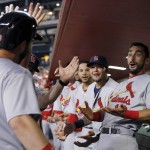 St. Louis Cardinals' Tony Cruz, left, celebrates his home run against the Arizona Diamondbacks with teammates, including Matt Carpenter, right, Yadier Molina, second from right, and Thomas Pham during the second inning of a baseball game Wednesday, Aug. 27, 2015, in Phoenix. (AP Photo/Ross D. Franklin)