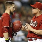 Arizona Diamondbacks manager Chip Hale, right, talks to Ender Inciarte after Inciarte was almost hit by Oakland Athletics relief pitcher Drew Pomeranz in the ninth inning during a baseball game, Sunday, Aug. 30, 2015, in Phoenix. (AP Photo/Rick Scuteri)