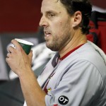 St. Louis Cardinals' John Lackey sits in the dugout during the seventh inning of a baseball game against the Arizona Diamondbacks Wednesday, Aug. 26, 2015, in Phoenix.  Lackey was the winning pitcher in the Cardinals 3-1 win over the Diamondbacks. (AP Photo/Ross D. Franklin)