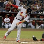St. Louis Cardinals' Thomas Pham, left, tags home plate as he gets around Arizona Diamondbacks' Welington Castillo, right, during the seventh inning of a baseball game Monday, Aug. 24, 2015, in Phoenix. (AP Photo/Ross D. Franklin)