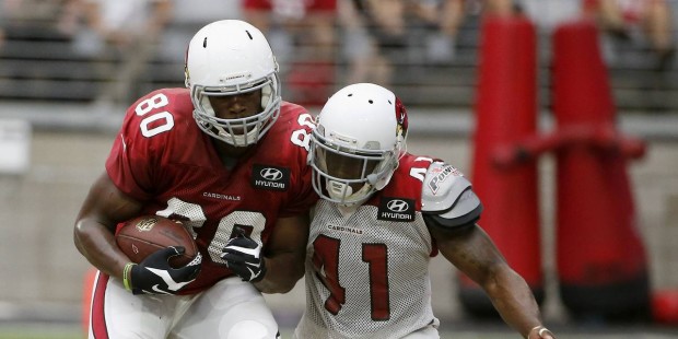 Arizona Cardinals' Ifeanyi Momah, left,  makes a catch in front of Gabe Martin, right, during an NF...