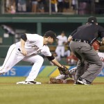 Pittsburgh Pirates second baseman Neil Walker, left, reaches to tag Arizona Diamondbacks' David Peralta as he tries to steal second base in the sixth inning of a baseball game, Monday, Aug. 17, 2015, in Pittsburgh. Peralta was initially called safe but replay overturned the call and he was ruled out. (AP Photo/Keith Srakocic)