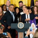 President Barack Obama puffs out his chest as former Phoenix Mercury guard Diana Taurasi presents him with an XL jersey in the East Room of the White House in Washington, Wednesday, Aug. 26, 2015, during a ceremony where the president honored the 2014 WNBA basketball Champions Phoenix Mercury. (AP Photo/Andrew Harnik)