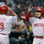 Cincinnati Reds' Eugenio Suarez (7) is congratulated by teammate Marlon Byrd after hitting a two-run home run against the Arizona Diamondbacks during the fourth inning of a baseball game, Saturday, Aug. 8, 2015, in Phoenix. (AP Photo/Ralph Freso)