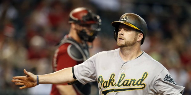 Oakland Athletics' Stephen Vogt reacts after hitting a solo home run against the Arizona Diamondbac...