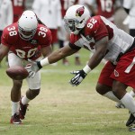 Arizona Cardinals' Frostee Rucker (92) tips the ball away on a pass intended for Andre Ellington (38) during NFL football training camp Thursday, Aug. 13, 2015, in Glendale, Ariz. (AP Photo/Ross D. Franklin)