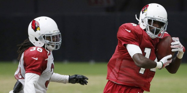 Arizona Cardinals' J.J. Nelson, right, catches a pass in front of defender C.J. Roberts (36) during...