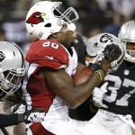 Arizona Cardinals tight end Ifeanyi Momah (80) is hit by Oakland Raiders' Brandian Ross (29) and Taylor Mays, center, during the second half of an NFL preseason football game in Oakland, Calif., Sunday, Aug. 30, 2015. The Cardinals won 30-23. (AP Photo/Tony Avelar)