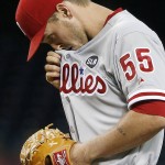 Philadelphia Phillies' David Buchanan wipes sweat from his face between pitches against the Arizona Diamondbacks during the first inning of a baseball game Tuesday, Aug. 11, 2015, in Phoenix. (AP Photo/Ross D. Franklin)