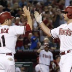 Arizona Diamondbacks' Paul Goldschmidt, right, celebrates his two-run home run against the Oakland Athletics with A.J. Pollock (11) during the seventh inning of a baseball game Friday, Aug. 28, 2015, in Phoenix. (AP Photo/Ross D. Franklin)