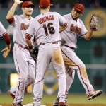 Arizona Diamondbacks' David Peralta, right, and A.J. Pollock, left, celebrate with teammate Chris Owings after defeating the Pittsburgh Pirates in a baseball game, Monday, Aug. 17, 2015, in Pittsburgh. The Diamondbacks won 4-1. (AP Photo/Keith Srakocic)