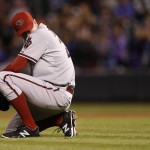 Arizona Diamondbacks relief pitcher Brad Ziegler reacts after committing a throwing error while fielding a single off the bat of Colorado Rockies' DJ LeMahieu to put the tying and go-ahead runs in scoring position in the ninth inning of a baseball game Monday, Aug. 31, 2015, in Denver. Colorado won 5-4. (AP Photo/David Zalubowski)
