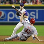 Arizona Diamondbacks' Chris Owings, top, looks to complete a double play as Cincinnati Reds' Jay Bruce slides into second during the fourth inning of a baseball game, Sunday, Aug. 9, 2015, in Phoenix. Owings was unable to complete the double play. (AP Photo/Ralph Freso)
