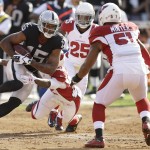 Oakland Raiders wide receiver Michael Crabtree (15) is tackled by Arizona Cardinals defensive back Tony Jefferson, bottom, while under pressure from cornerback Jerraud Powers (25) and linebacker Kevin Minter (51) during the first half of an NFL preseason football game in Oakland, Calif., Sunday, Aug. 30, 2015. (AP Photo/Ben Margot)