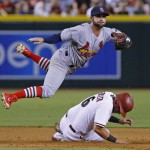 St. Louis Cardinals second baseman Greg Garcia, top, forces out Arizona Diamondbacks'  David Peralta (6) as he turns a double play in the sixth inning of a baseball game Monday, Aug. 24, 2015, in Phoenix. (David Kadlubowski/The Arizona Republic via AP)  MARICOPA COUNTY OUT; MAGS OUT; NO SALES; MANDATORY CREDIT