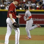 Arizona Diamondbacks' Patrick Corbin, left, flips a new baseball into the air after giving up a home run to St. Louis Cardinals' Mark Reynolds, right, during the fifth inning of a baseball game Wednesday, Aug. 26, 2015, in Phoenix. (AP Photo/Ross D. Franklin)