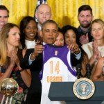 President Barack Obama holds up an Phoenix Mercury basketball jersey presented to him by the team during a ceremony in the East Room of the White House in Washington, Wednesday, Aug. 26, 2015, where he honored the 2014 WNBA basketball Champions Phoenix Mercury. (AP Photo/Andrew Harnik)